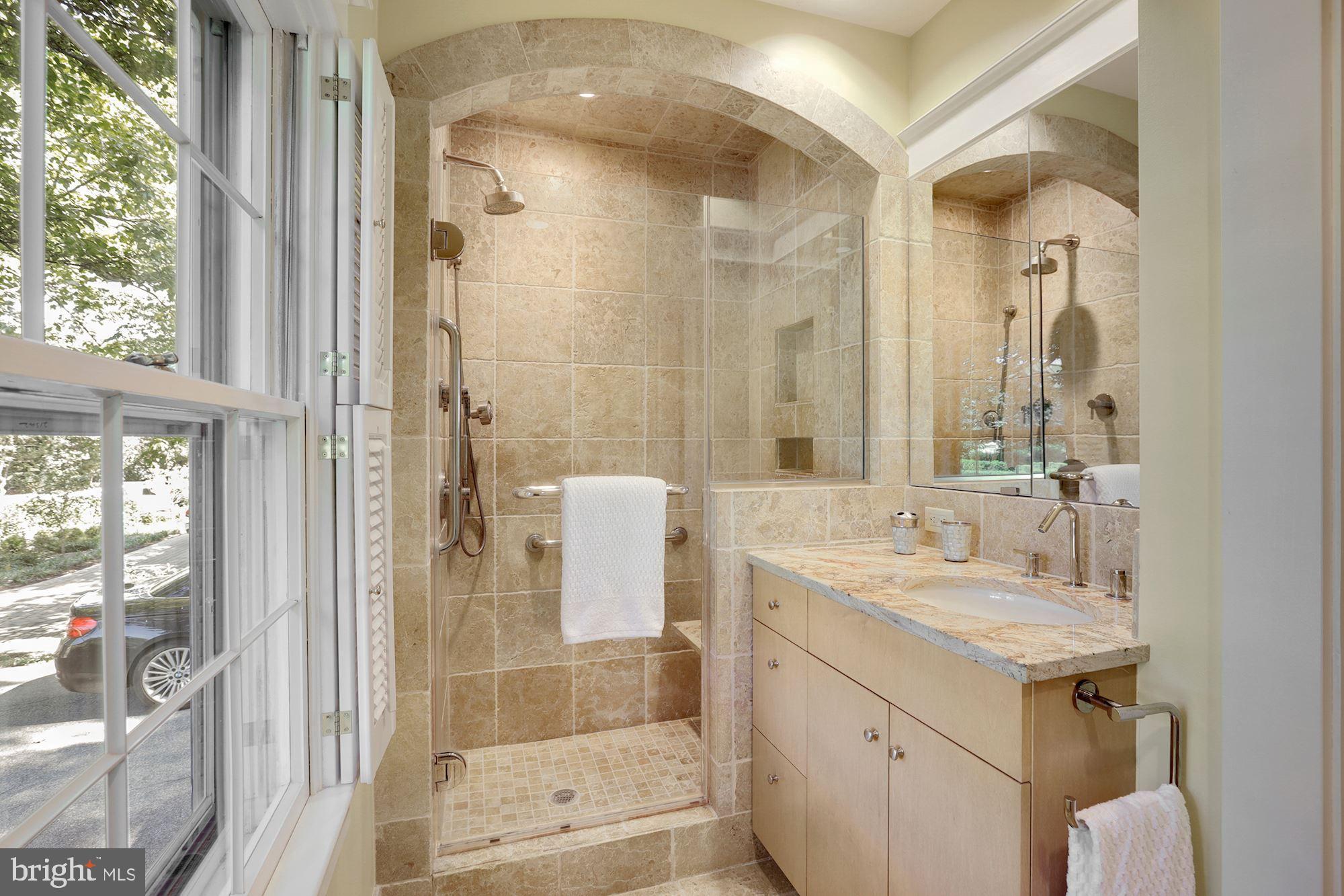 3720 Bradley Lane Chevy Chase, MD 20815 - Photo 16 of 29 a bathroom with a sink and a mirror