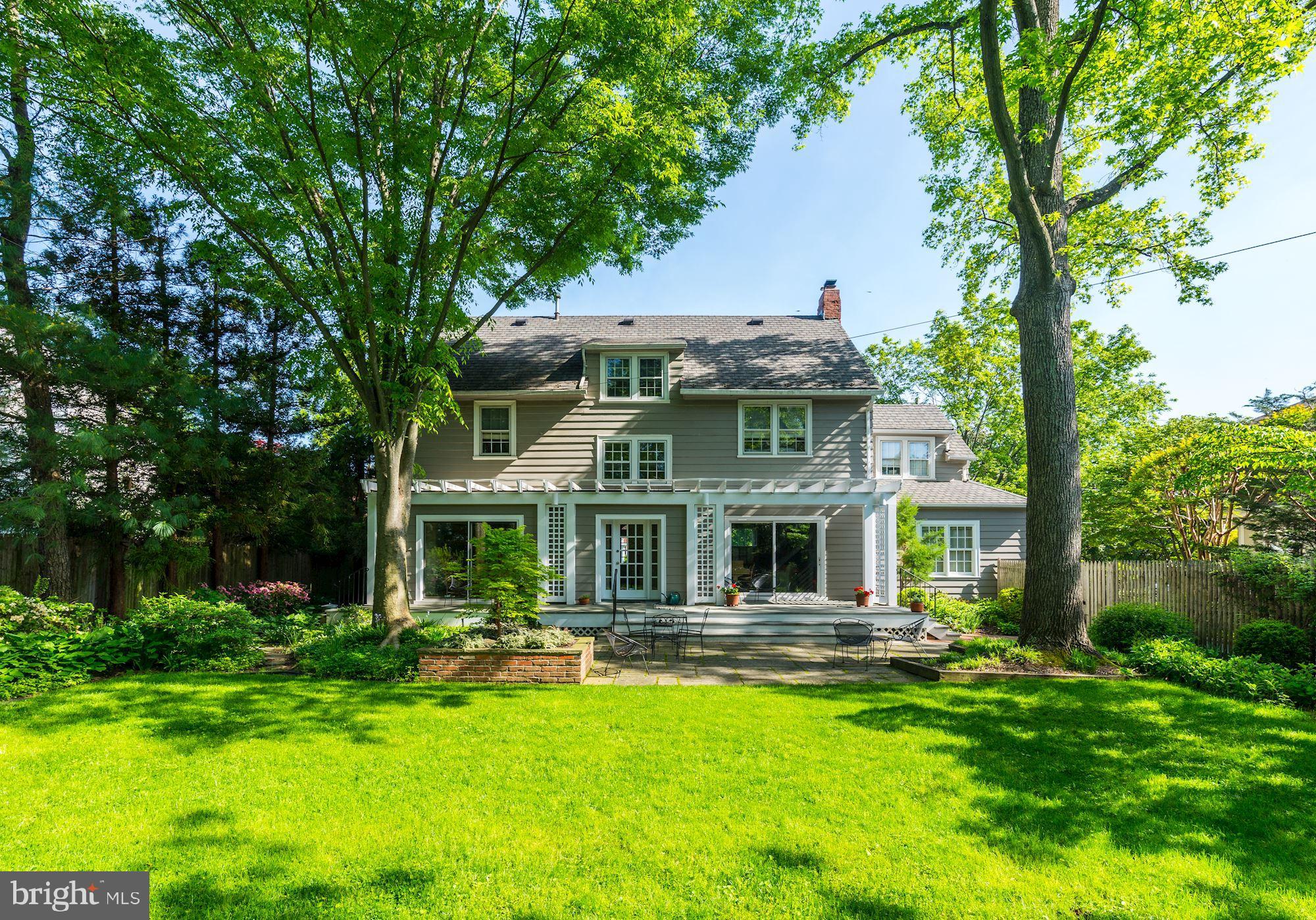 3720 Bradley Lane Chevy Chase, MD 20815 - Photo 3 of 29 a front view of a house with a yard table and chairs