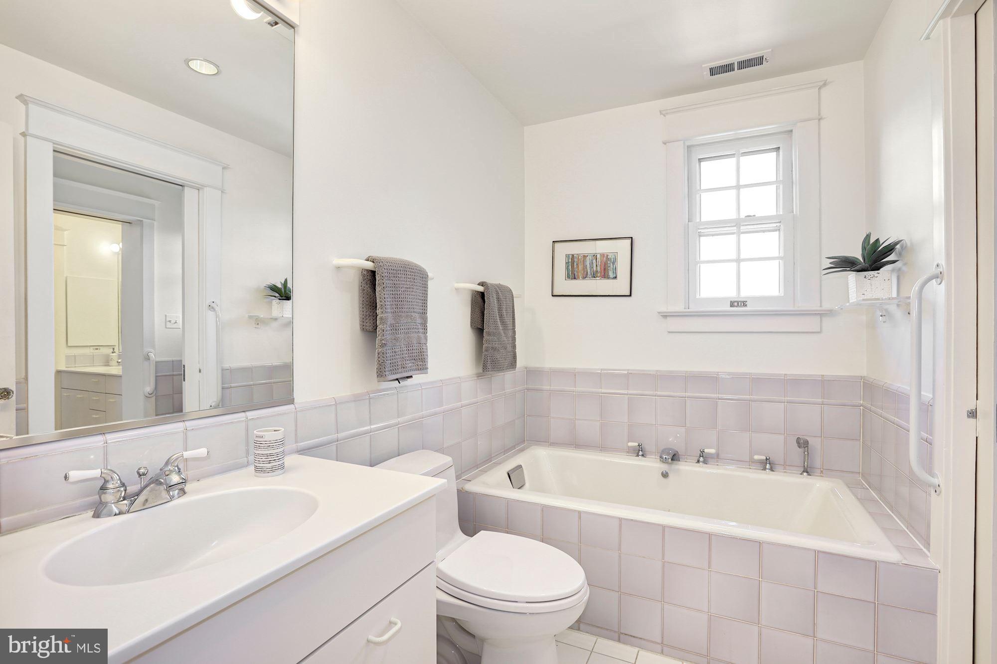 3720 Bradley Lane Chevy Chase, MD 20815 - Photo 22 of 29 a bathroom with a bathtub shower sink mirror vanity and toilet