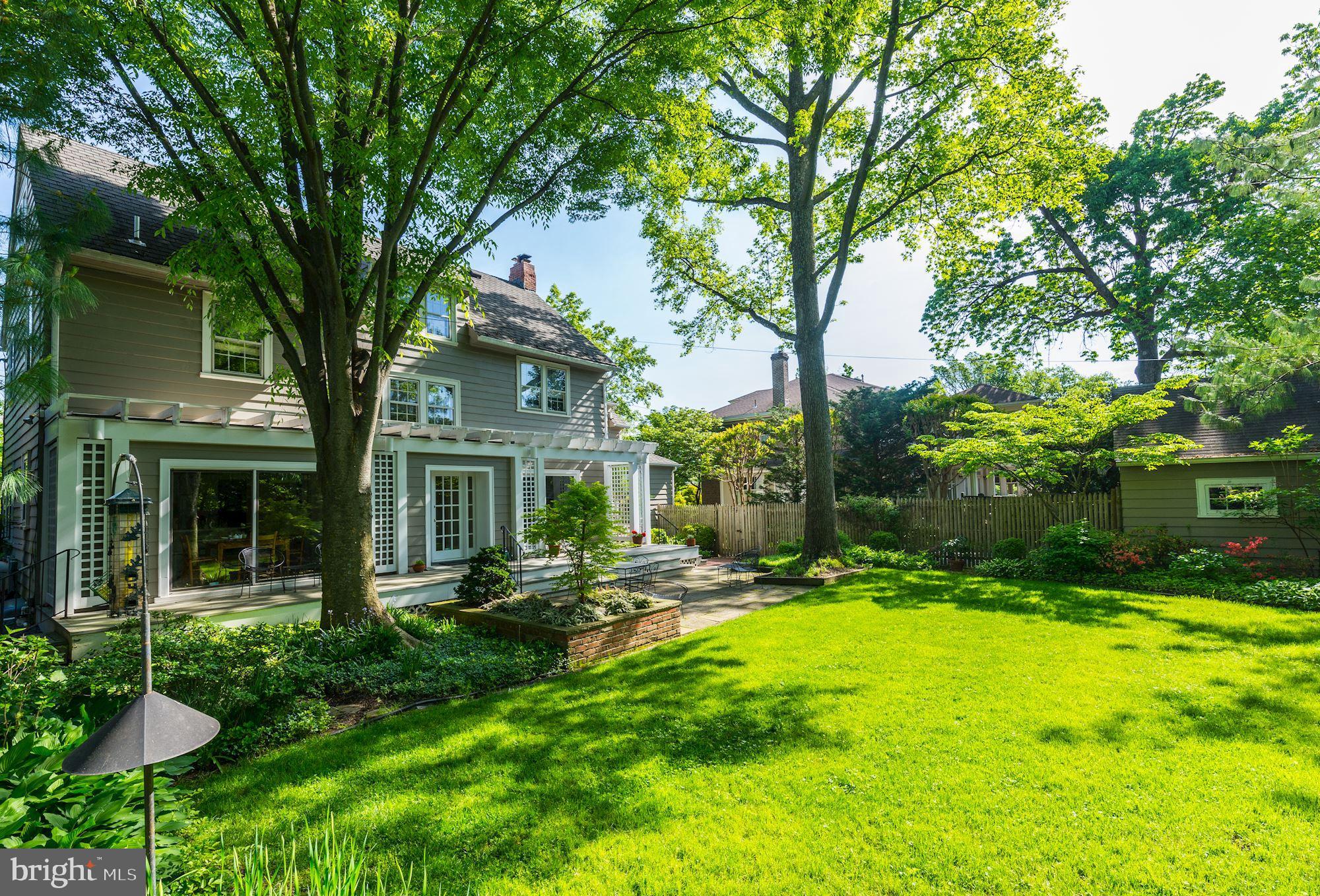 3720 Bradley Lane Chevy Chase, MD 20815 - Photo 4 of 29 a view of a chair and table in backyard of the house