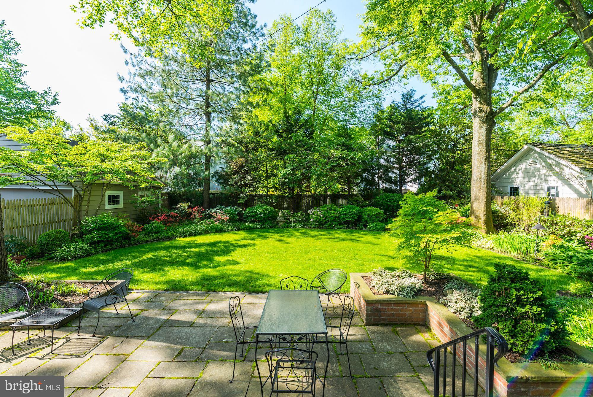 3720 Bradley Lane Chevy Chase, MD 20815 - Photo 6 of 29 a patio with table and chairs and potted plants