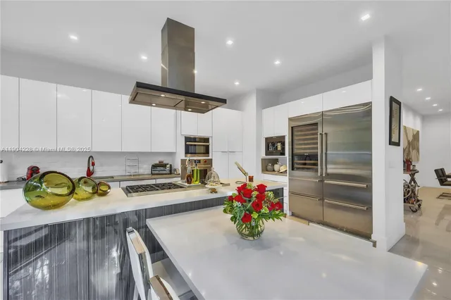 a kitchen with a refrigerator and a stove top oven