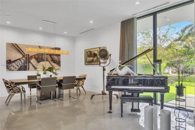 a living room with furniture a wooden floor and a window