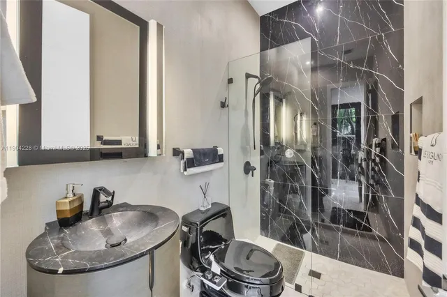 a bathroom with a sink a toilet and a mirror