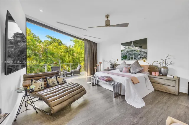 a spacious bedroom with a bed and a large window