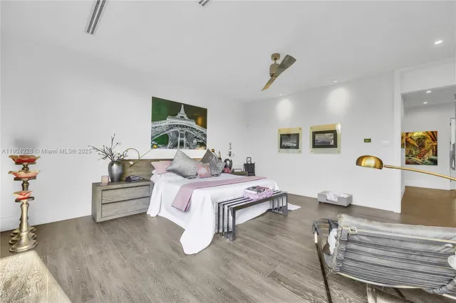 a bedroom with furniture and a wooden floor