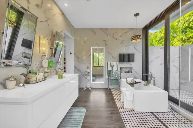 a bathroom with a sink a mirror and a shower