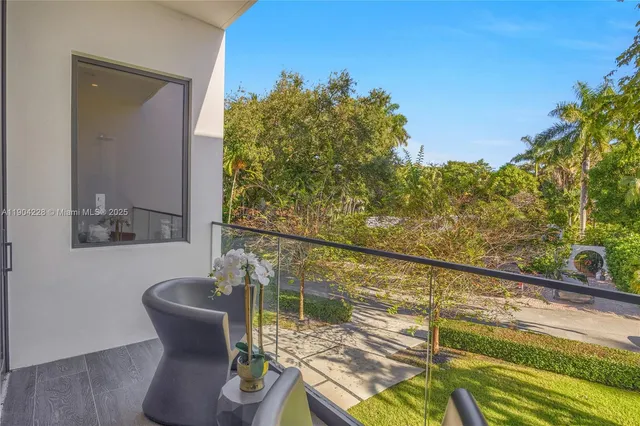 a bedroom with a bed and large windows