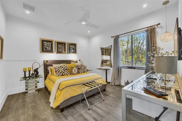 a bathroom with a sink a toilet a mirror and shower