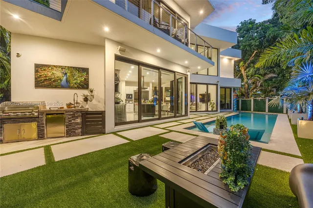 a view of a swimming pool with chairs and floor to ceiling window