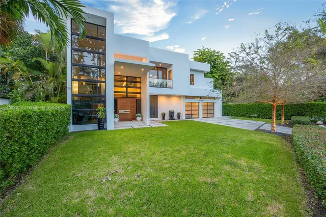 an aerial view of a house with a yard