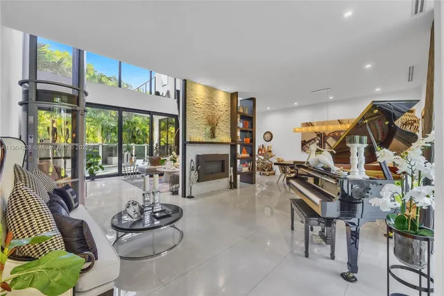 a living room with furniture and a floor to ceiling window