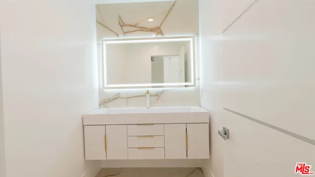 a bathroom with a sink a vanity and a mirror