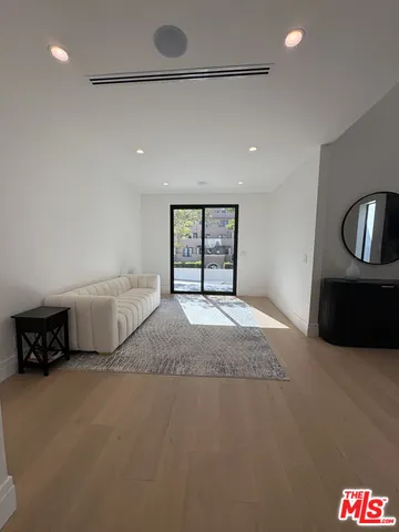 a spacious bedroom with a bed and dresser