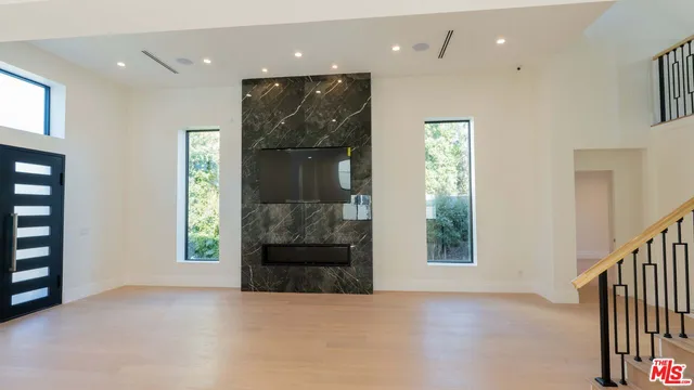 an empty room with windows and entryway