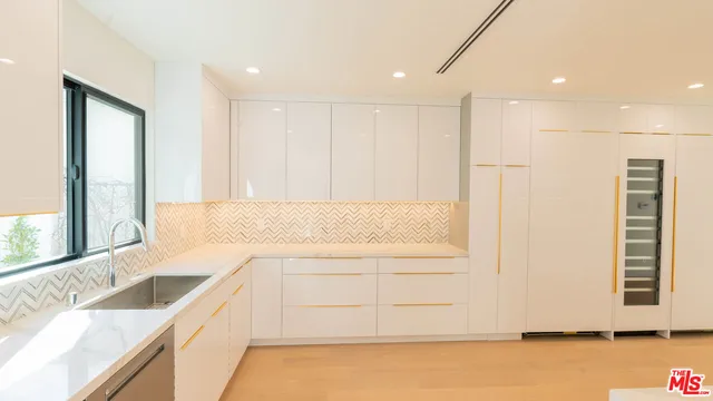 a view of a kitchen with a sink and a large window