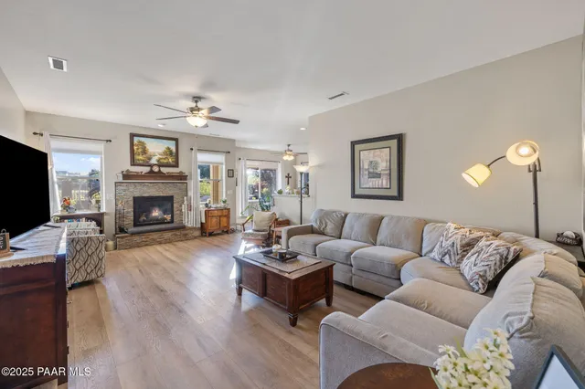 a living room with furniture a fireplace and a flat screen tv