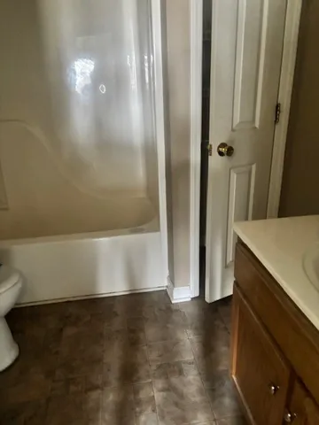 a view of a room with wooden floor and a cabinet