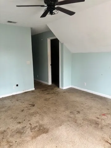 a view of a room with a ceiling fan