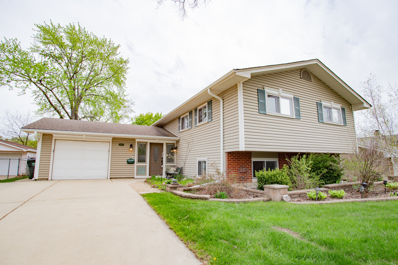 a front view of house with yard and green space