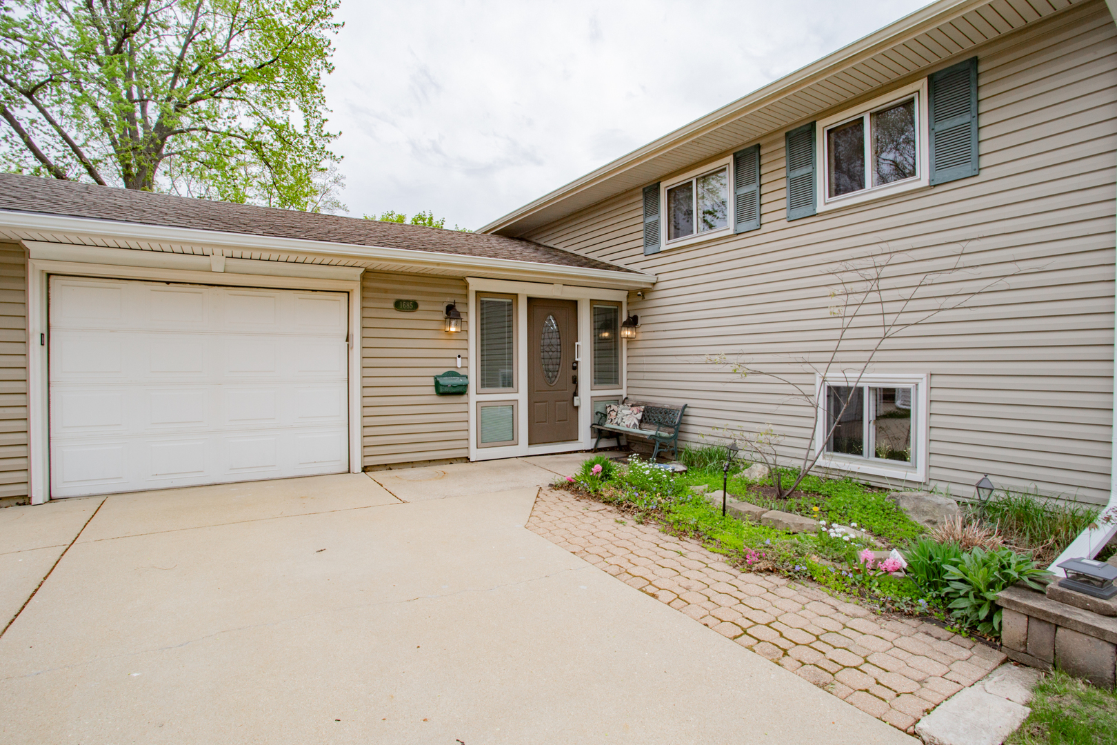 1685 Kent Road Hoffman Estates, IL 60169 - Photo 2 of 31 a front view of a house with a yard and garage
