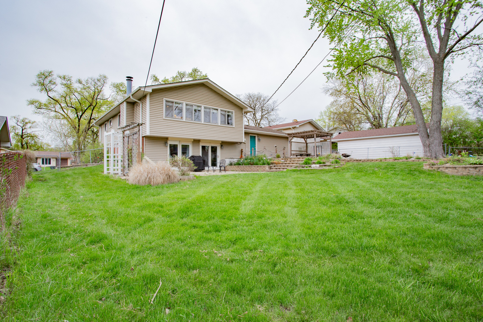 1685 Kent Road Hoffman Estates, IL 60169 - Photo 29 of 31 a front view of a house with a yard table and chairs