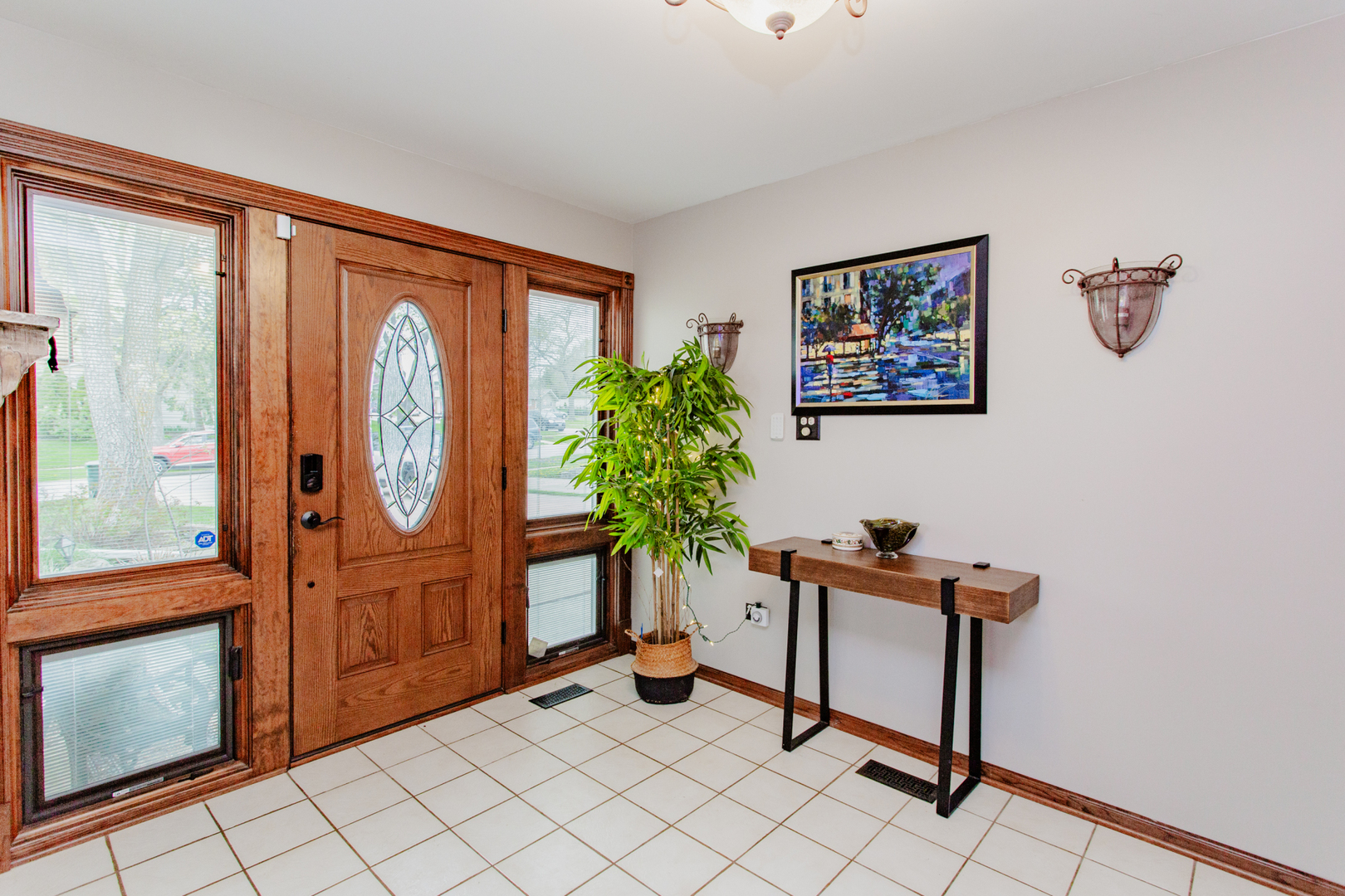 1685 Kent Road Hoffman Estates, IL 60169 - Photo 3 of 31 a living room with furniture a window and potted plants