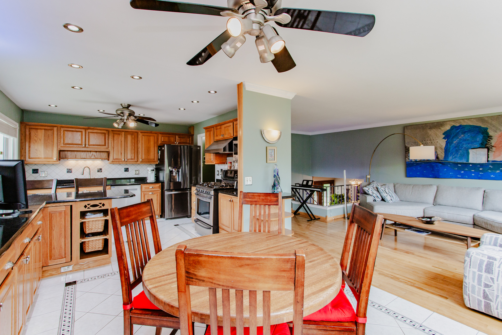 1685 Kent Road Hoffman Estates, IL 60169 - Photo 7 of 31 a dining room with stainless steel appliances kitchen island granite countertop a table chairs and a refrigerator