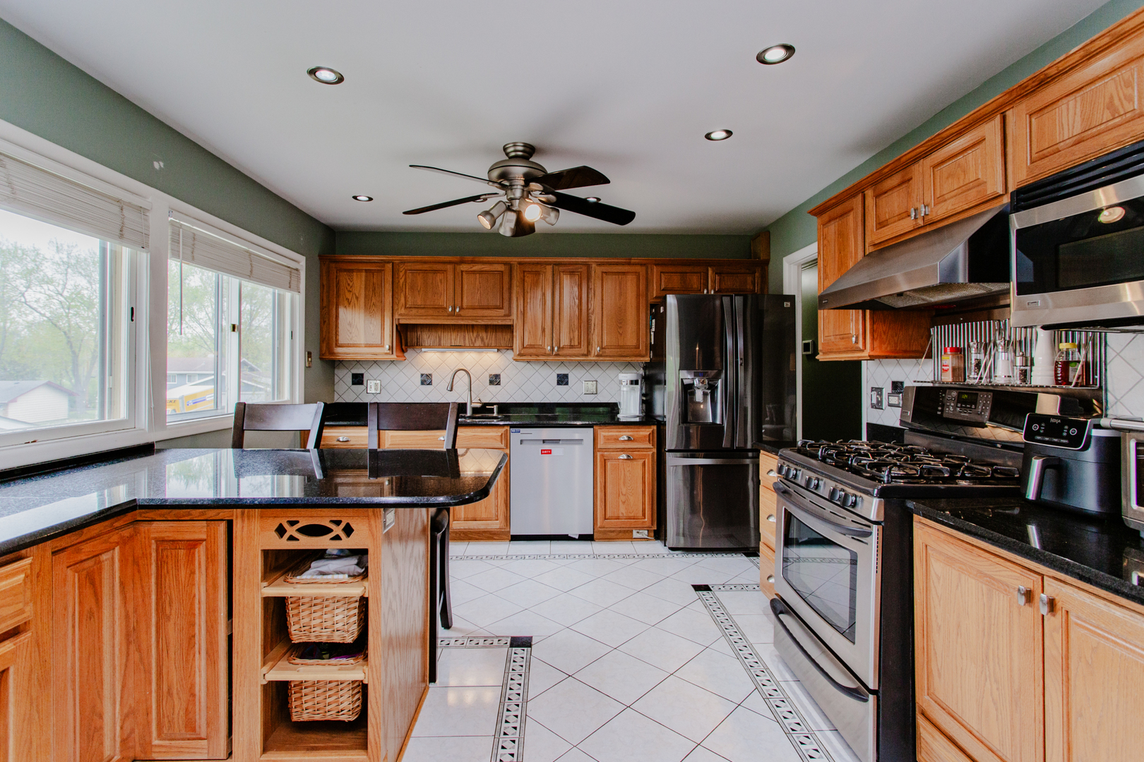 1685 Kent Road Hoffman Estates, IL 60169 - Photo 10 of 31 a kitchen with stainless steel appliances a stove sink microwave and cabinets