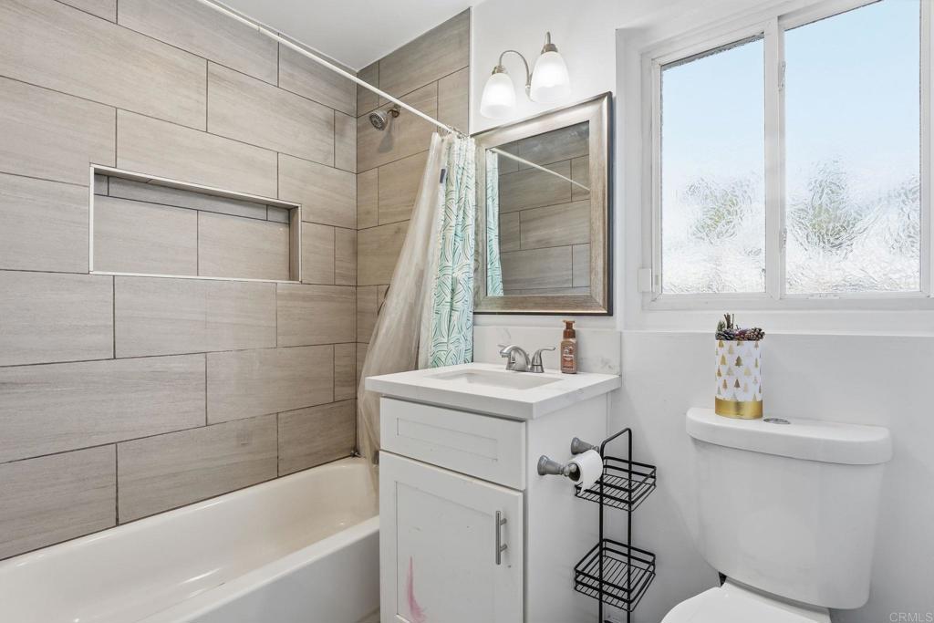 738 Carlsbad Street Spring Valley, CA 91977 - Photo 19 of 40 a bathroom with a sink mirror toilet and bathtub