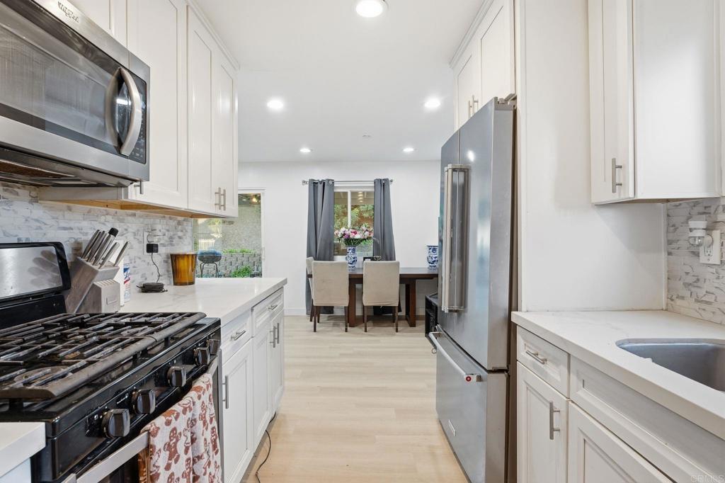 738 Carlsbad Street Spring Valley, CA 91977 - Photo 2 of 40 a kitchen with a sink stove and refrigerator