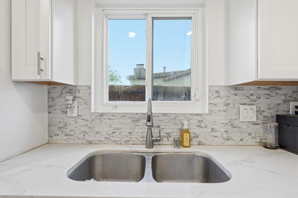 738 Carlsbad Street Spring Valley, CA 91977 - Photo 26 of 40 a kitchen with a sink and a mirror