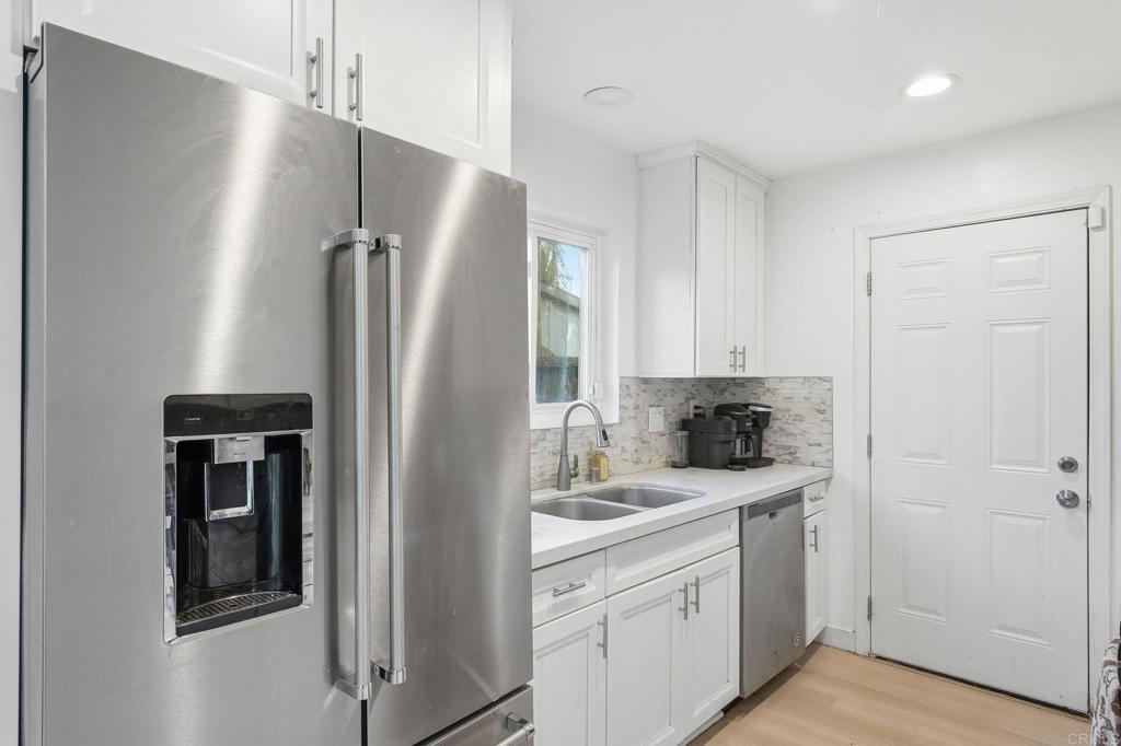 738 Carlsbad Street Spring Valley, CA 91977 - Photo 27 of 40 a kitchen with stainless steel appliances a refrigerator and a stove top oven