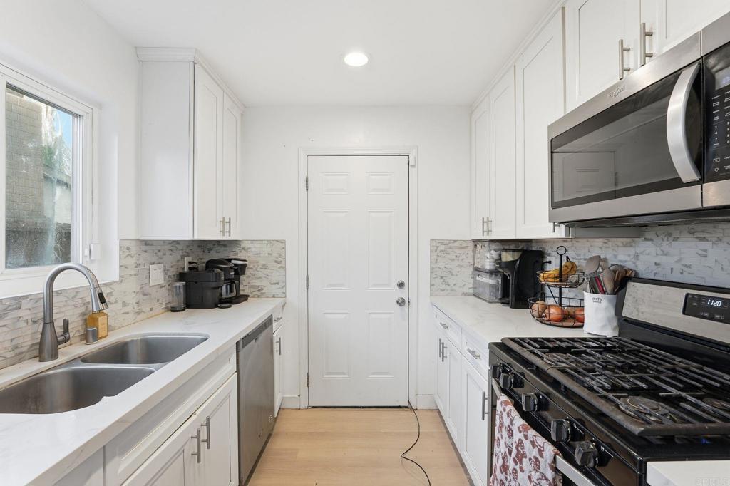 738 Carlsbad Street Spring Valley, CA 91977 - Photo 29 of 40 a kitchen with stainless steel appliances a stove a sink a refrigerator and cabinets