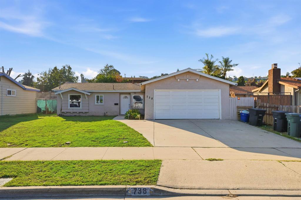 738 Carlsbad Street Spring Valley, CA 91977 - Photo 40 of 40 a front view of a house with a yard and garage