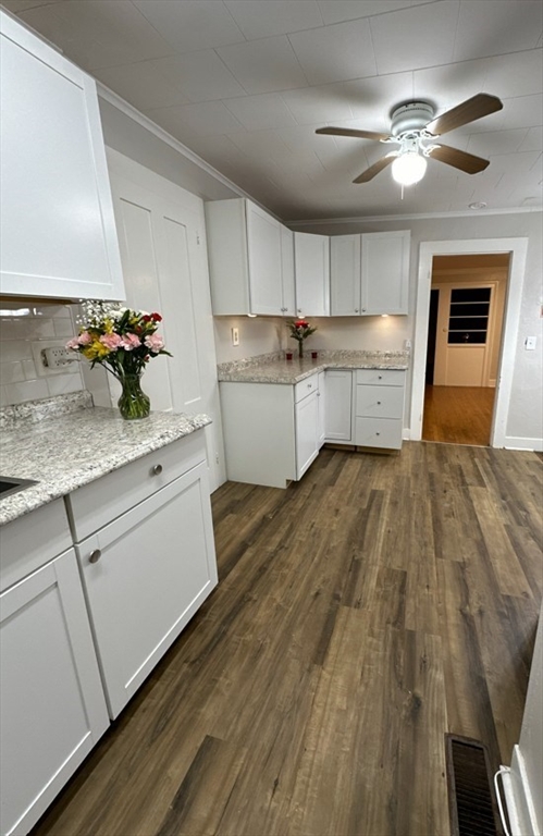 26 Green Street Monson, MA 01057 - Photo 12 of 38 a kitchen with a sink dishwasher and white cabinets with wooden floor