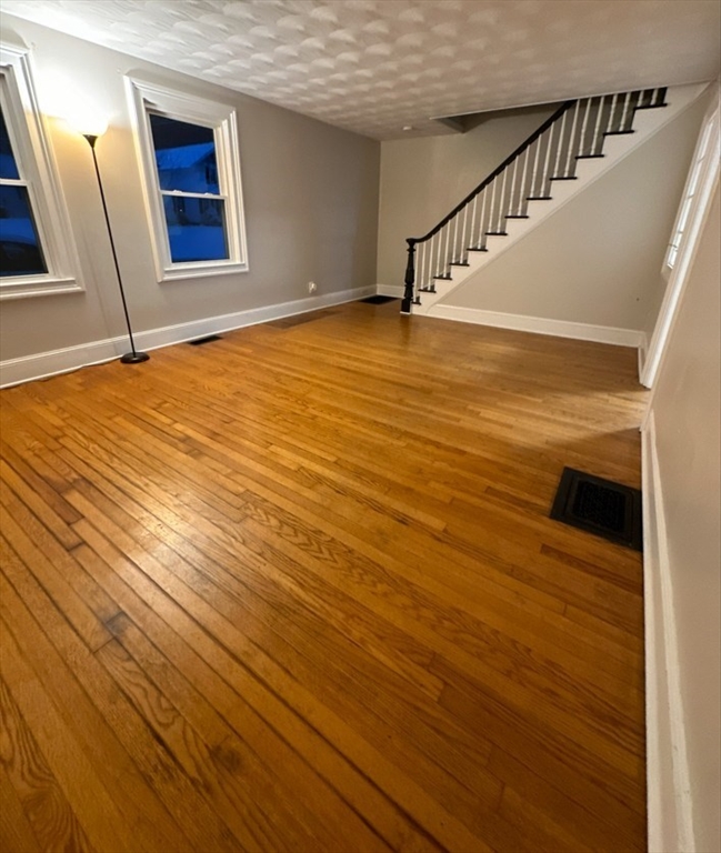 26 Green Street Monson, MA 01057 - Photo 22 of 38 a view of an empty room with wooden floor and a window