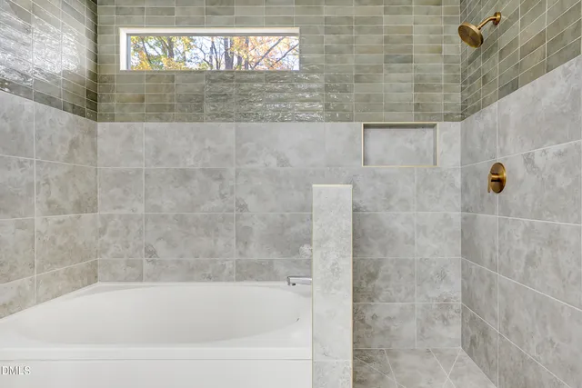 a view of a big room with wooden floor and windows