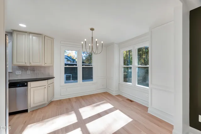 a view of empty room with wooden floor and fireplace