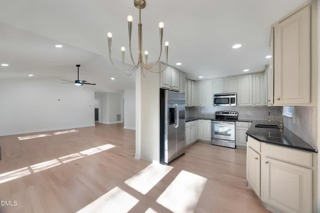 a view of an empty room with a fireplace and a window