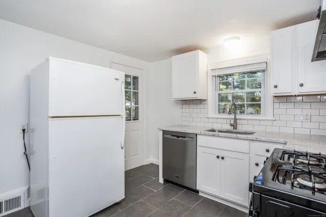 a kitchen with a refrigerator sink and stove