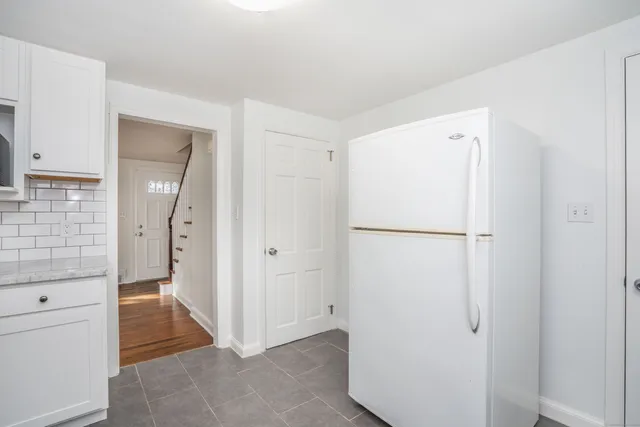 a view of a hallway with closet and wooden floor