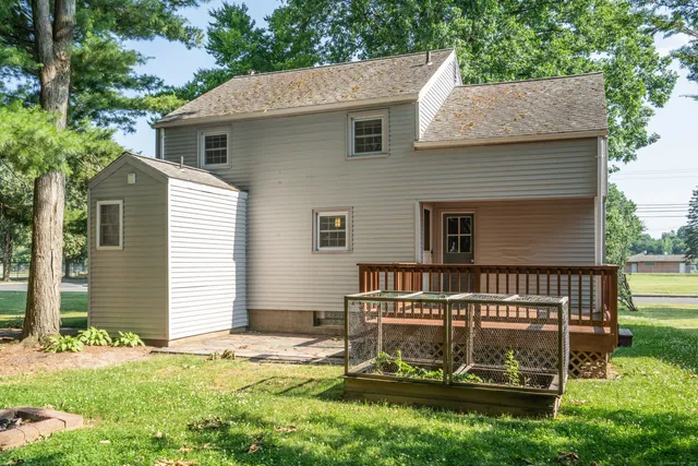 a view of a house with yard and a garden
