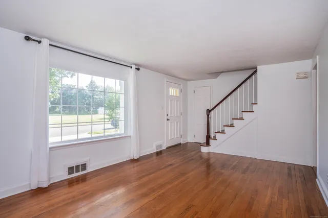 a view of an entryway with wooden floor and windows
