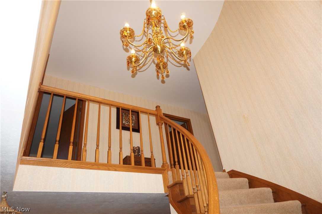 Lovely curved wall, wide hall and unique chandelier