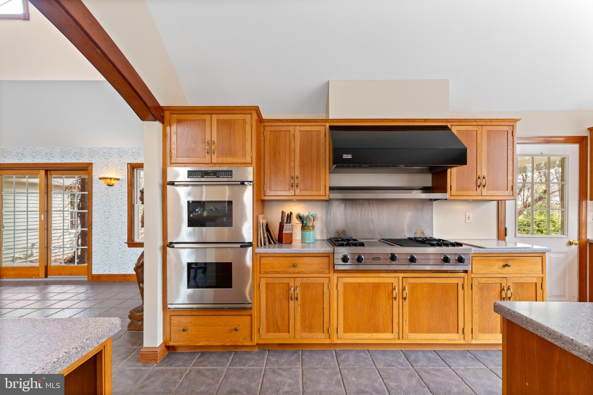 40 Christman Road Kutztown, PA 19530 - Photo 16 of 48 a kitchen with stainless steel appliances a stove a microwave and wooden cabinets