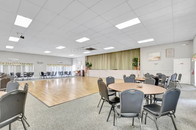 a kitchen with a dining table chairs and view living room