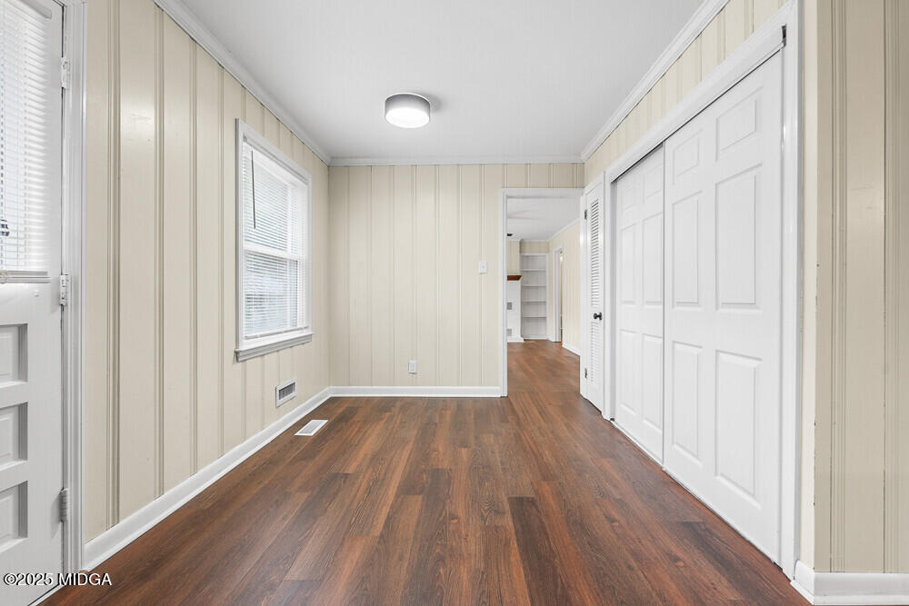 127 Edna Place Warner Robins, GA 31093 - Photo 11 of 26 a view of an empty room with wooden floor and a window
