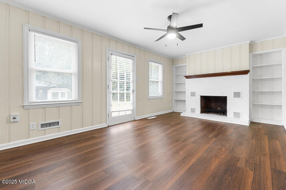 127 Edna Place Warner Robins, GA 31093 - Photo 12 of 26 a view of an empty room with wooden floor and a window