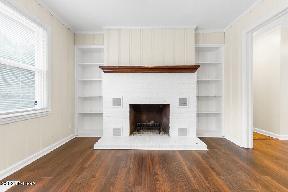 127 Edna Place Warner Robins, GA 31093 - Photo 13 of 26 a living room with a fireplace and wooden floor